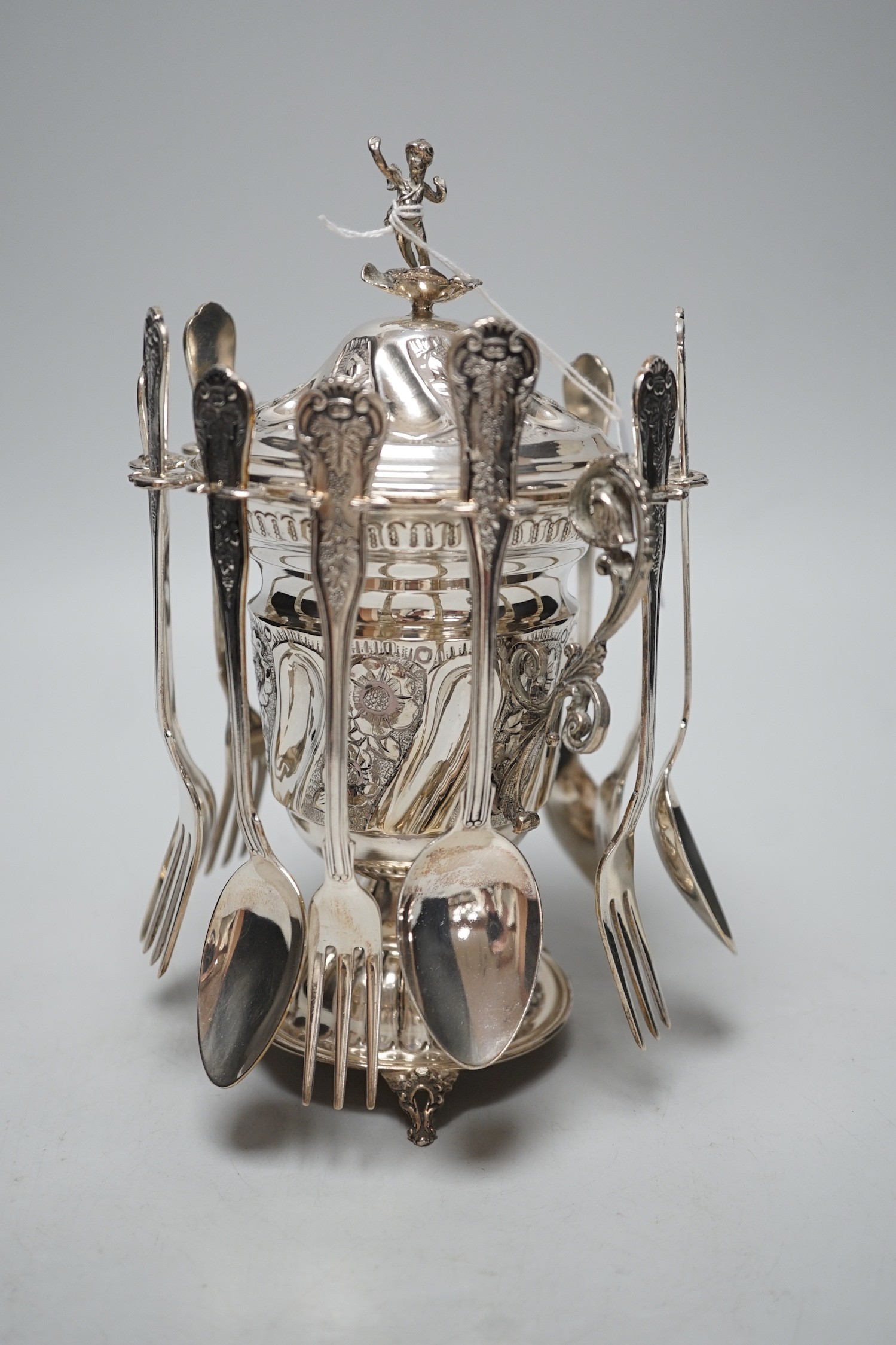 A modern Greek 925 dessert set, comprising an embossed pedestal cup and cover with cherub finial and six hanging spoons and six forks, height 21.6cm, with box
